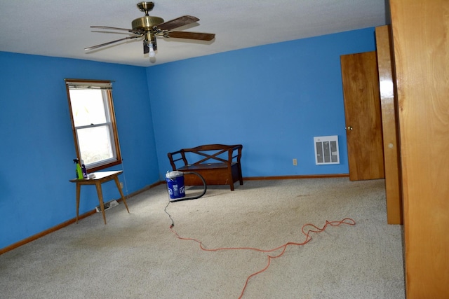 unfurnished bedroom with carpet floors, baseboards, visible vents, and a ceiling fan