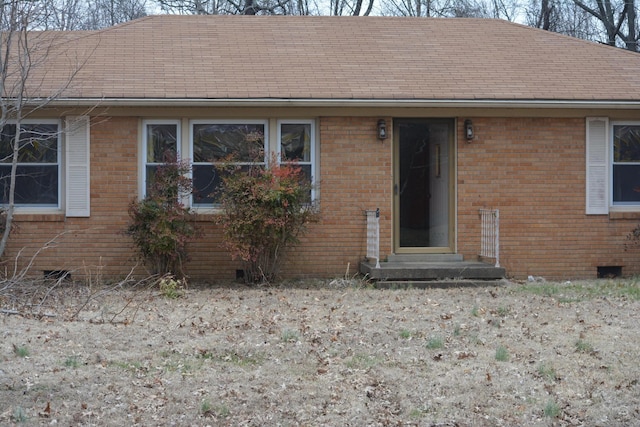 single story home with crawl space, brick siding, and roof with shingles