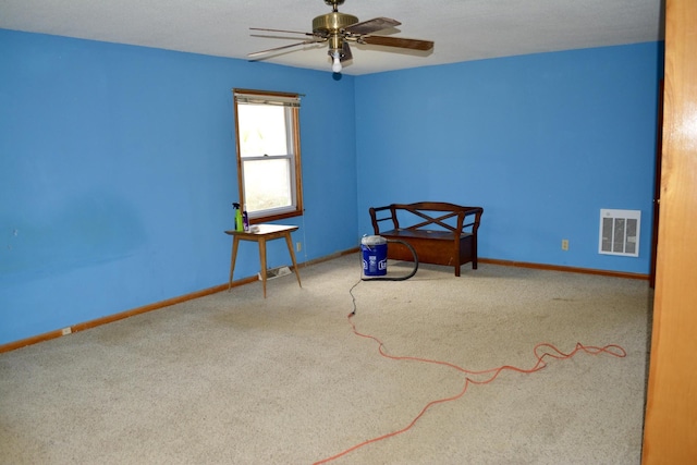 interior space with a ceiling fan, carpet, visible vents, and baseboards