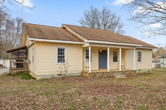 view of front facade featuring a shingled roof, crawl space, and covered porch