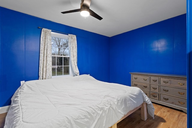 bedroom featuring wood finished floors and a ceiling fan