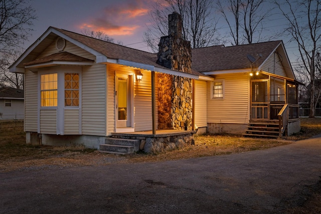 view of front facade with a porch and a shingled roof