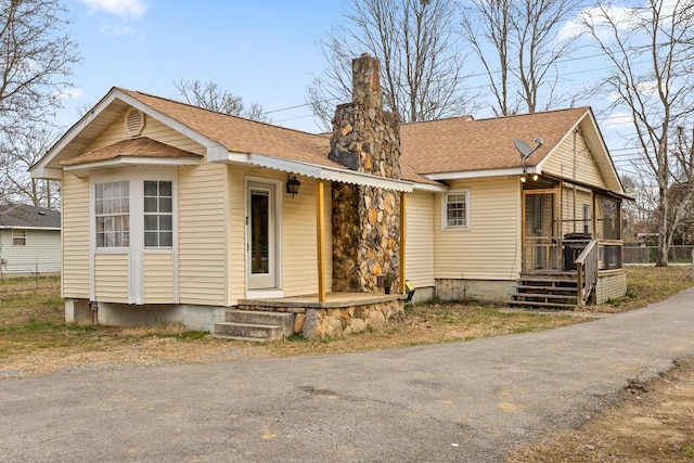 view of front of property with a shingled roof and covered porch