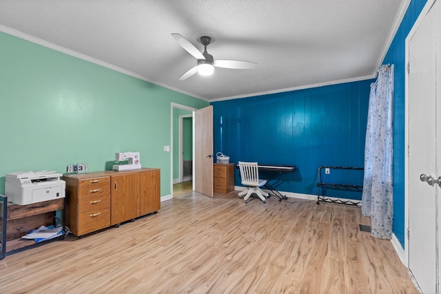 office space with a textured ceiling, ceiling fan, ornamental molding, and wood finished floors