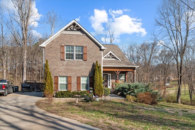 view of front facade featuring brick siding and driveway