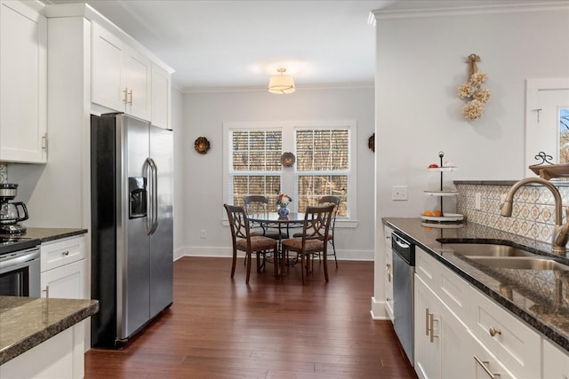 kitchen featuring a sink, dark wood-type flooring, appliances with stainless steel finishes, and crown molding