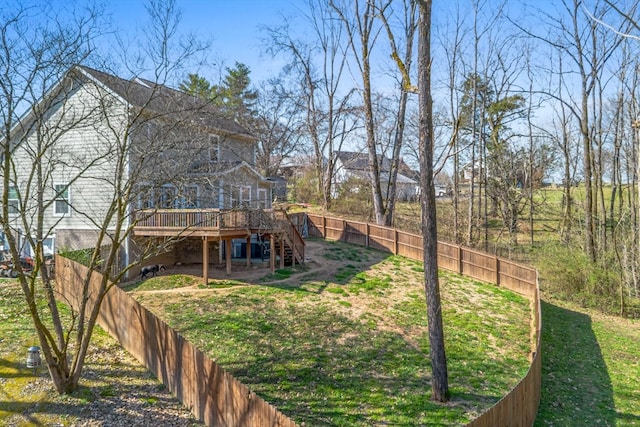 view of yard with stairs, a deck, and fence