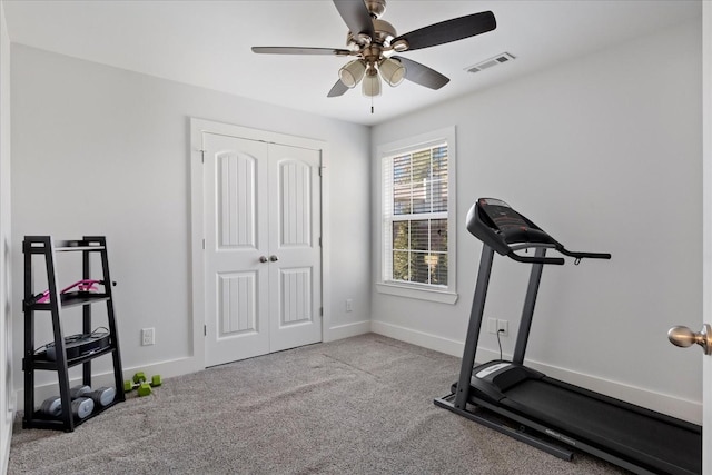 exercise room with a ceiling fan, visible vents, carpet floors, and baseboards