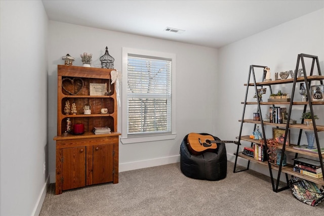 sitting room with carpet flooring, baseboards, and visible vents