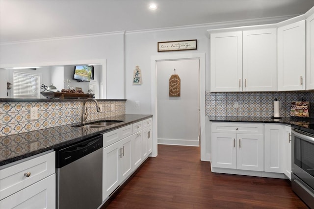 kitchen featuring ornamental molding, a sink, dark stone countertops, appliances with stainless steel finishes, and decorative backsplash