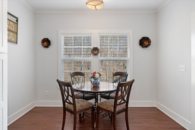 dining room with dark wood-style floors, crown molding, and baseboards