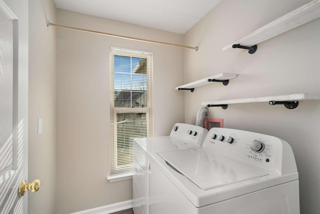 clothes washing area featuring baseboards, laundry area, and washer and dryer