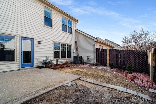 rear view of house featuring cooling unit, a patio area, and fence