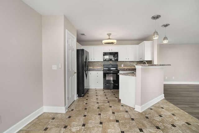 kitchen featuring tasteful backsplash, white cabinetry, black appliances, a peninsula, and baseboards