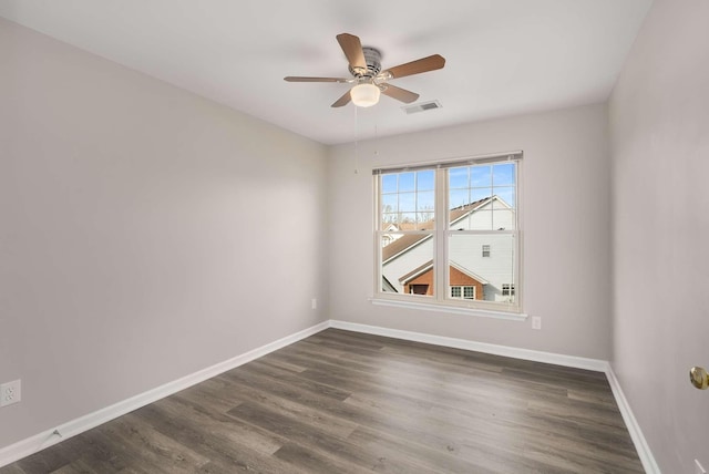 unfurnished room featuring a ceiling fan, baseboards, visible vents, and dark wood-style flooring