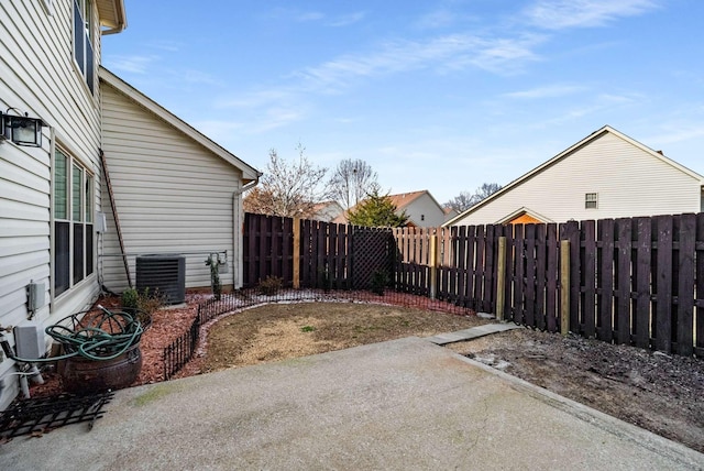 view of yard featuring central air condition unit, a patio area, and a fenced backyard