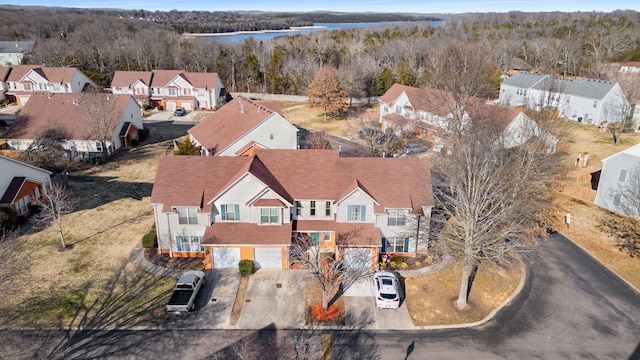 bird's eye view with a water view, a residential view, and a wooded view