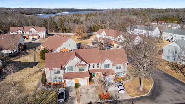 birds eye view of property featuring a residential view and a wooded view