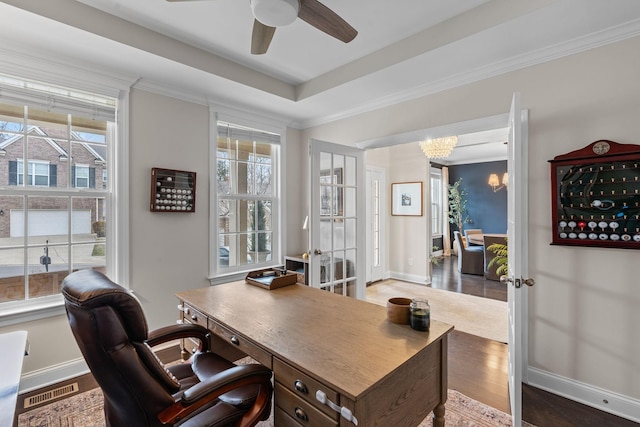 home office with a healthy amount of sunlight, crown molding, and wood finished floors