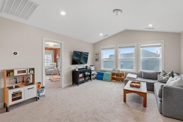 living area featuring light colored carpet, visible vents, vaulted ceiling, and recessed lighting