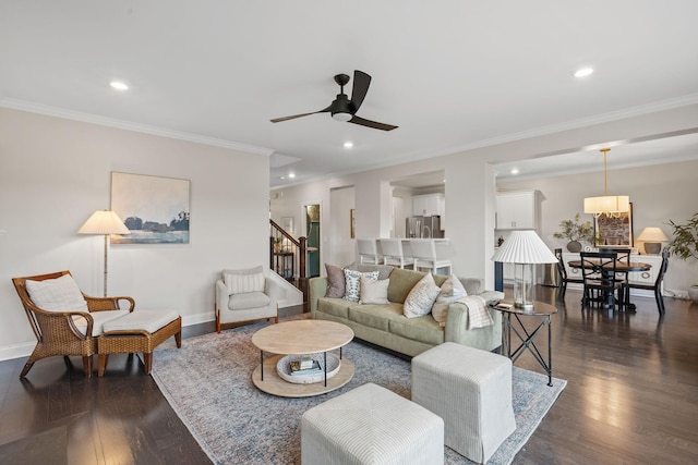 living room featuring dark wood-type flooring, recessed lighting, baseboards, and stairs