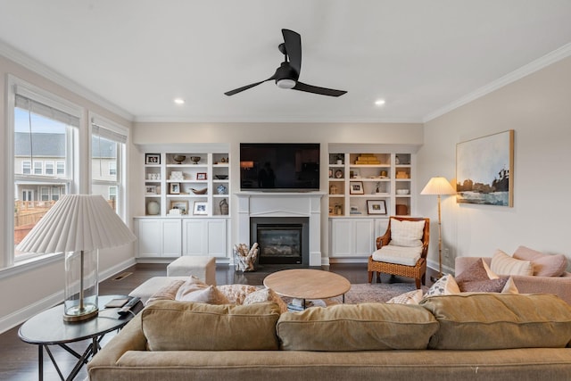 living room featuring baseboards, dark wood-style flooring, a fireplace with flush hearth, and crown molding