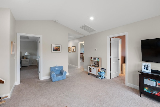 sitting room featuring lofted ceiling, light carpet, visible vents, and baseboards