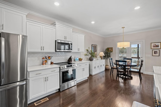 kitchen featuring stainless steel appliances, light countertops, visible vents, and crown molding