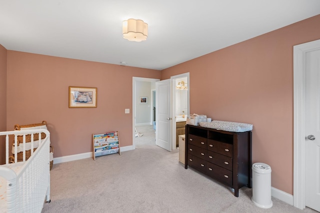 bedroom featuring light colored carpet and baseboards