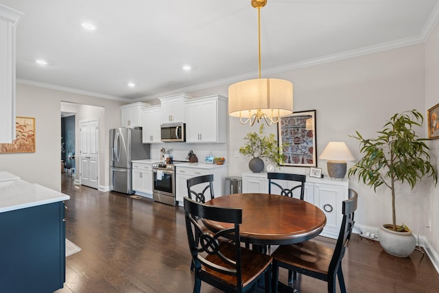 dining space featuring dark wood-style floors, ornamental molding, and baseboards