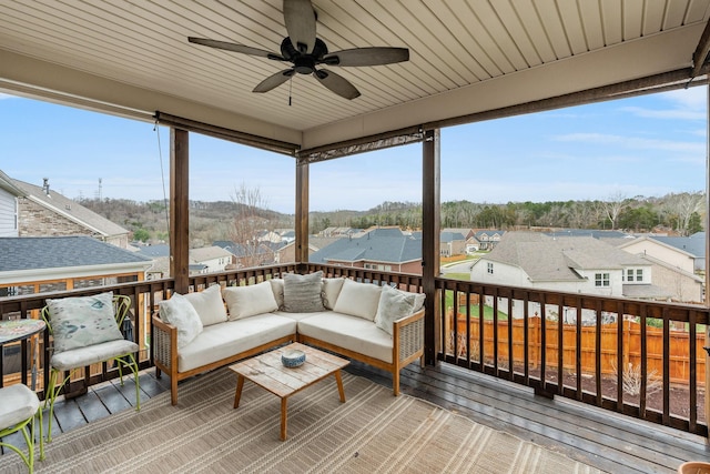 wooden deck featuring an outdoor hangout area, ceiling fan, and a residential view