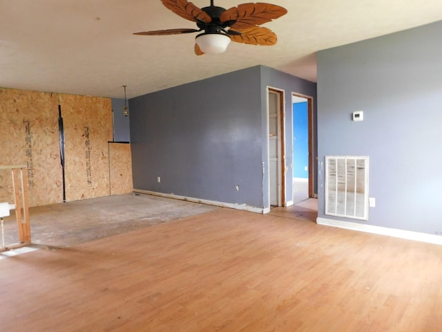 unfurnished room with baseboards, light wood finished floors, visible vents, and a ceiling fan