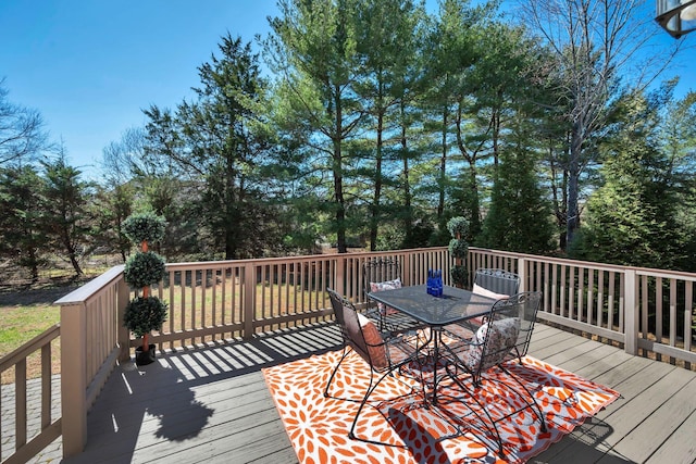 wooden terrace featuring outdoor dining space