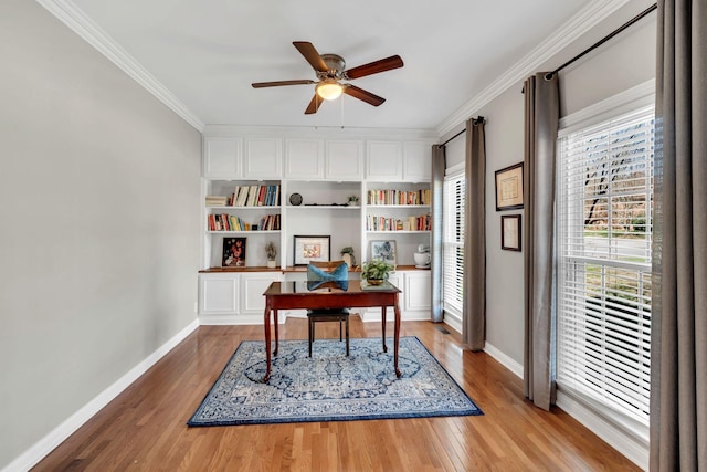 home office with light wood finished floors, ceiling fan, baseboards, and crown molding