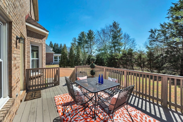 wooden deck featuring outdoor dining space