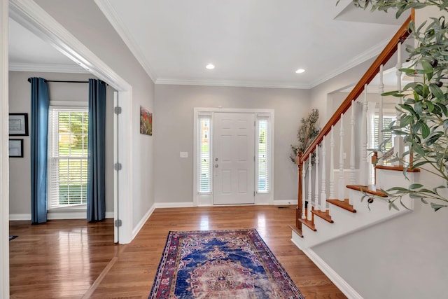 entryway featuring crown molding, recessed lighting, stairway, wood finished floors, and baseboards