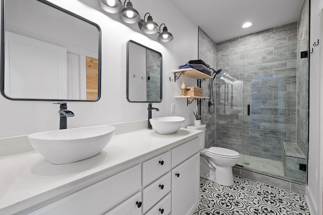 bathroom with toilet, a stall shower, tile patterned flooring, and a sink