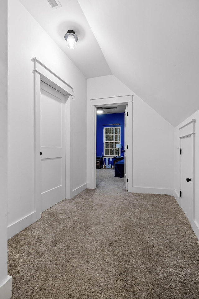 bonus room featuring carpet floors, vaulted ceiling, and baseboards