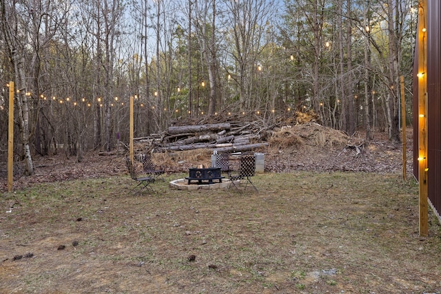 view of yard with an outdoor fire pit