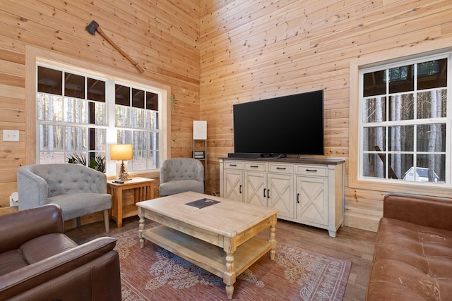 living room with wooden walls and light wood-style floors