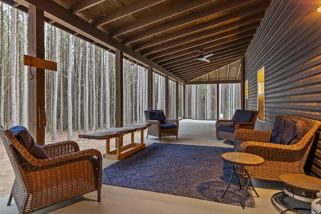 sunroom featuring vaulted ceiling and plenty of natural light