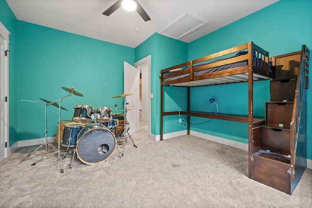 carpeted bedroom featuring attic access, baseboards, and ceiling fan