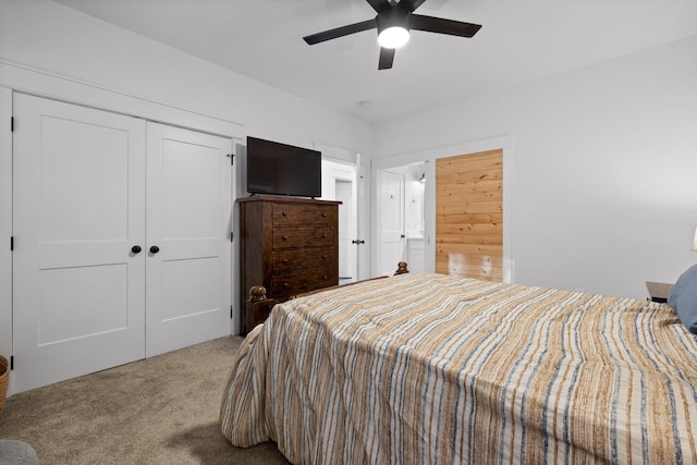 bedroom featuring carpet, a closet, a ceiling fan, and ensuite bathroom