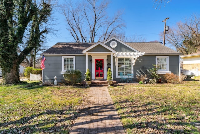 bungalow featuring a front yard, fence, and a pergola