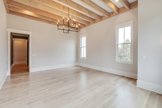 empty room with a notable chandelier, beamed ceiling, light wood-style flooring, and baseboards