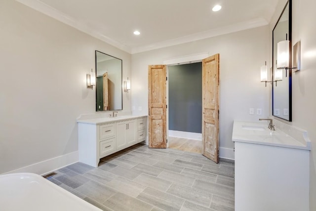 full bath featuring ornamental molding, baseboards, and a sink