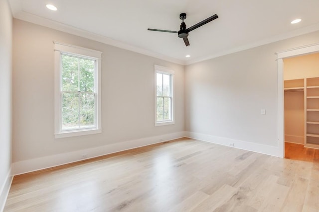 empty room featuring crown molding, baseboards, light wood-type flooring, recessed lighting, and a ceiling fan