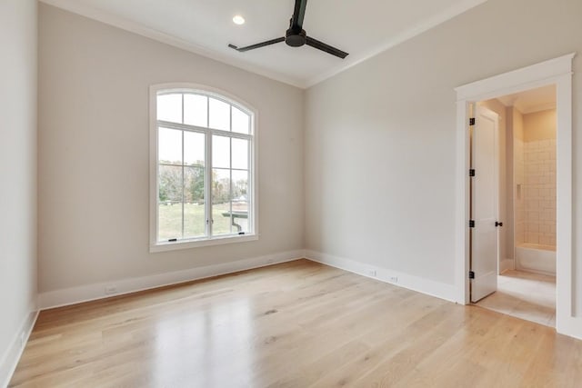 unfurnished room featuring crown molding, baseboards, light wood-type flooring, and ceiling fan