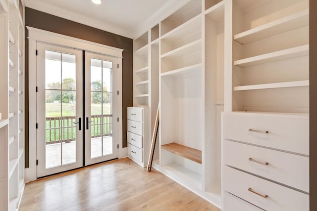 doorway to outside featuring light wood-type flooring, french doors, and built in shelves