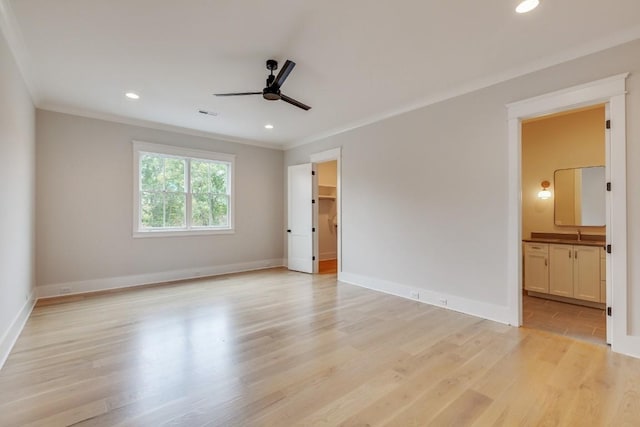 unfurnished bedroom featuring baseboards, visible vents, light wood-style flooring, recessed lighting, and crown molding